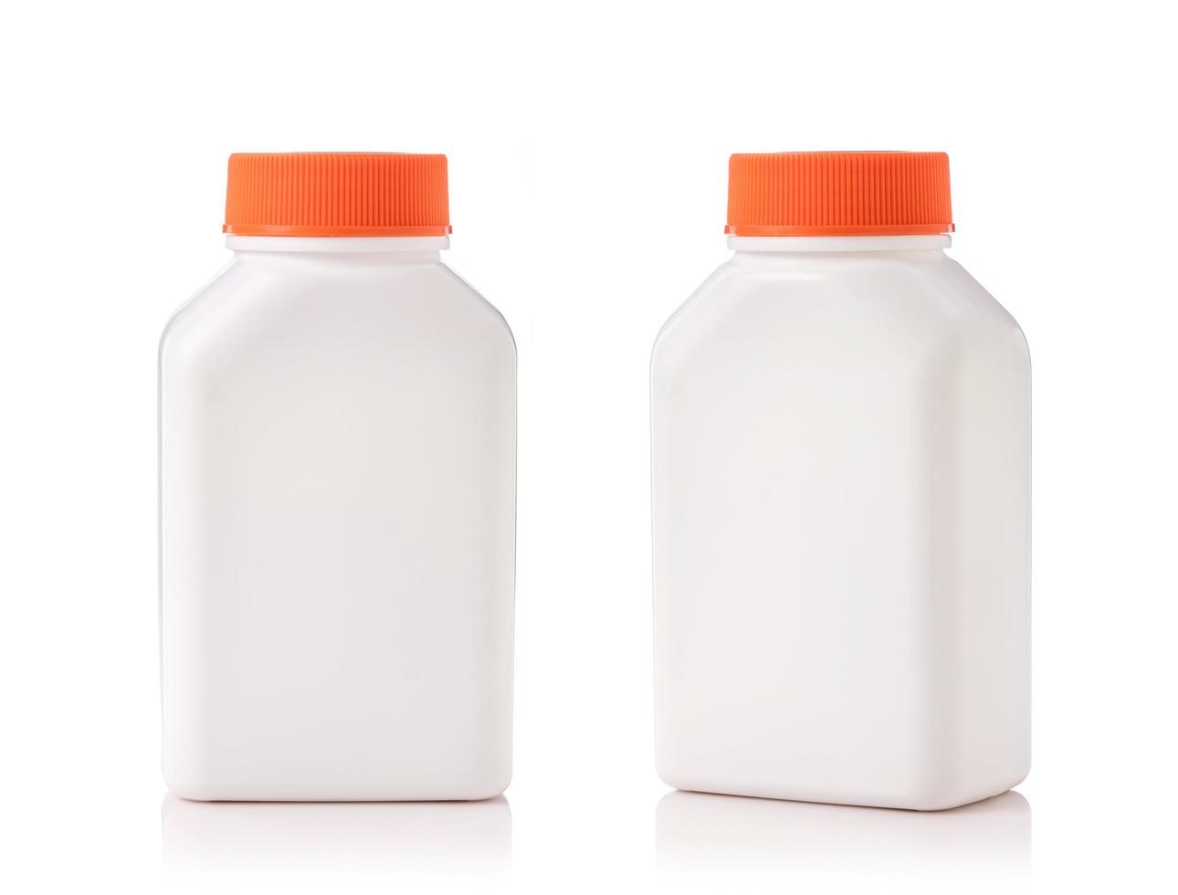 Blank white plastic bottle with red cap. Studio shot isolated on white photo