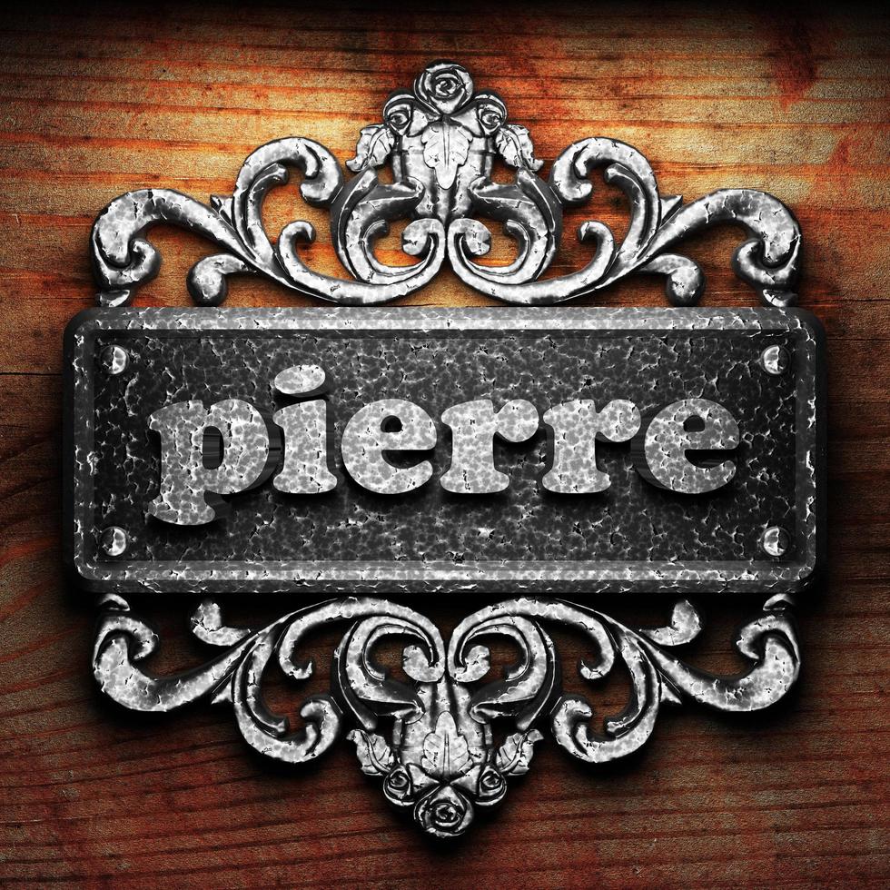 pierre word of iron on wooden background photo