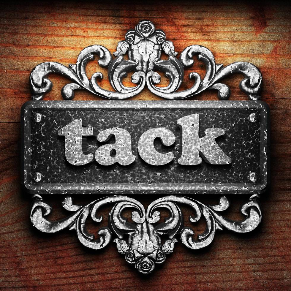 tack word of iron on wooden background photo