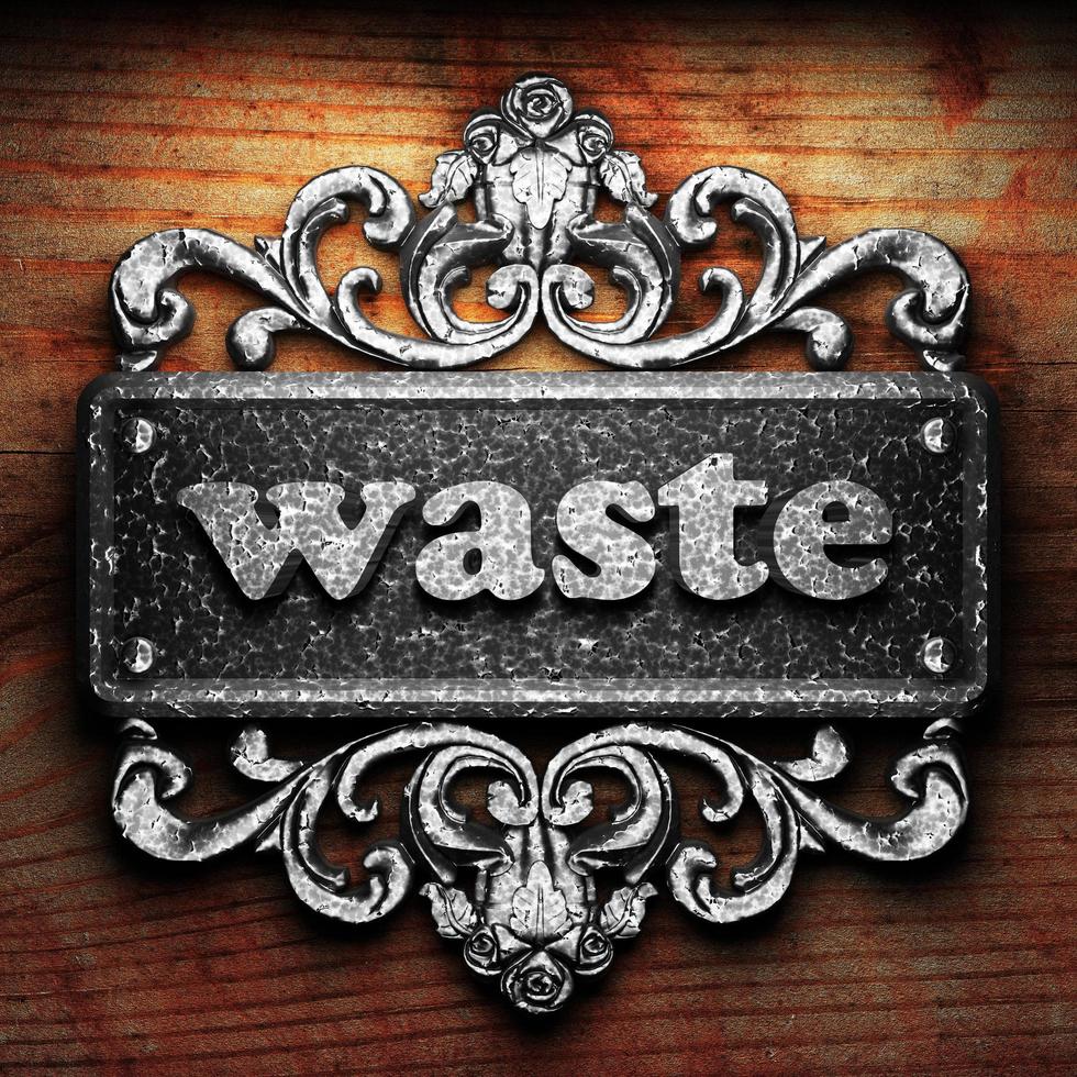 waste word of iron on wooden background photo