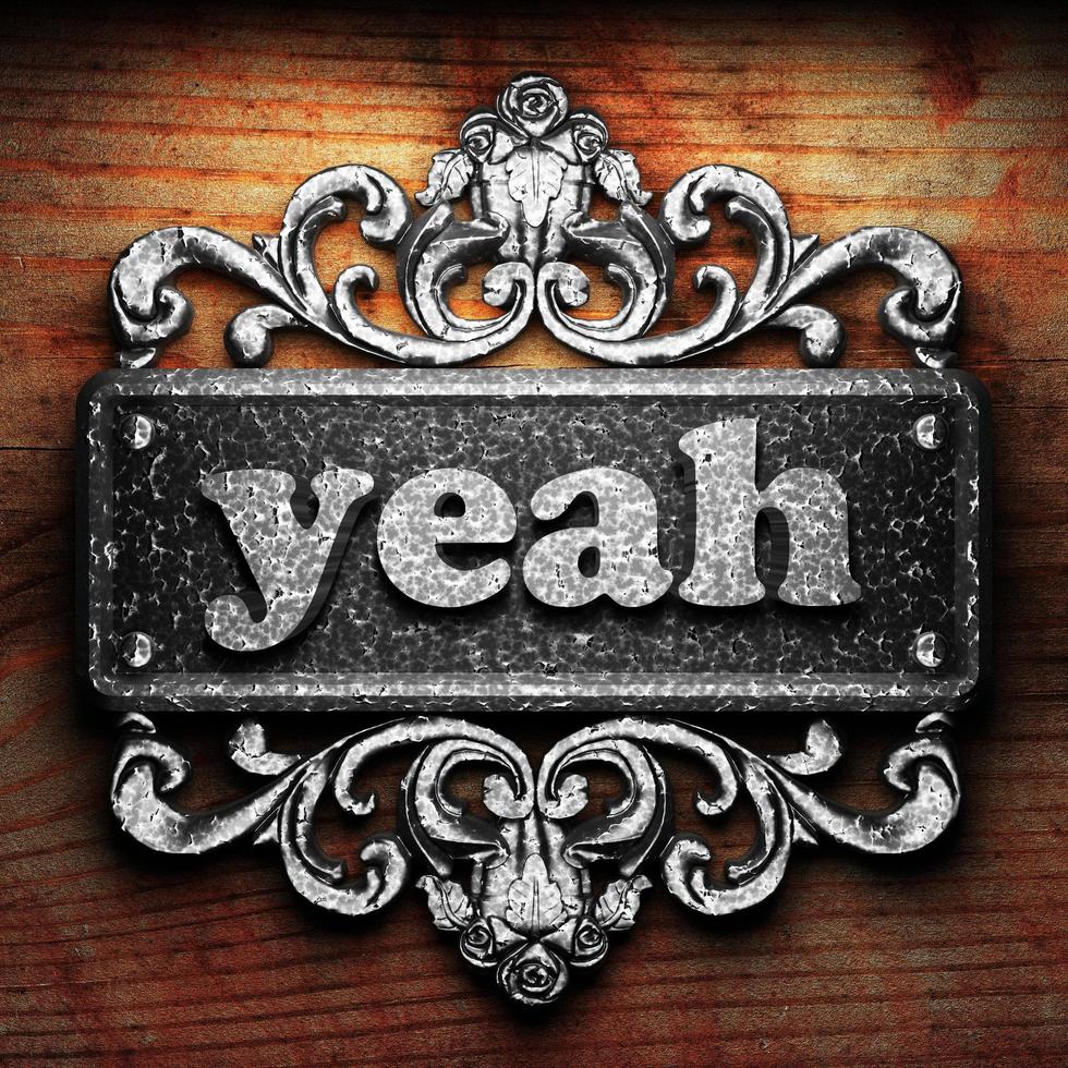 yeah word of iron on wooden background photo