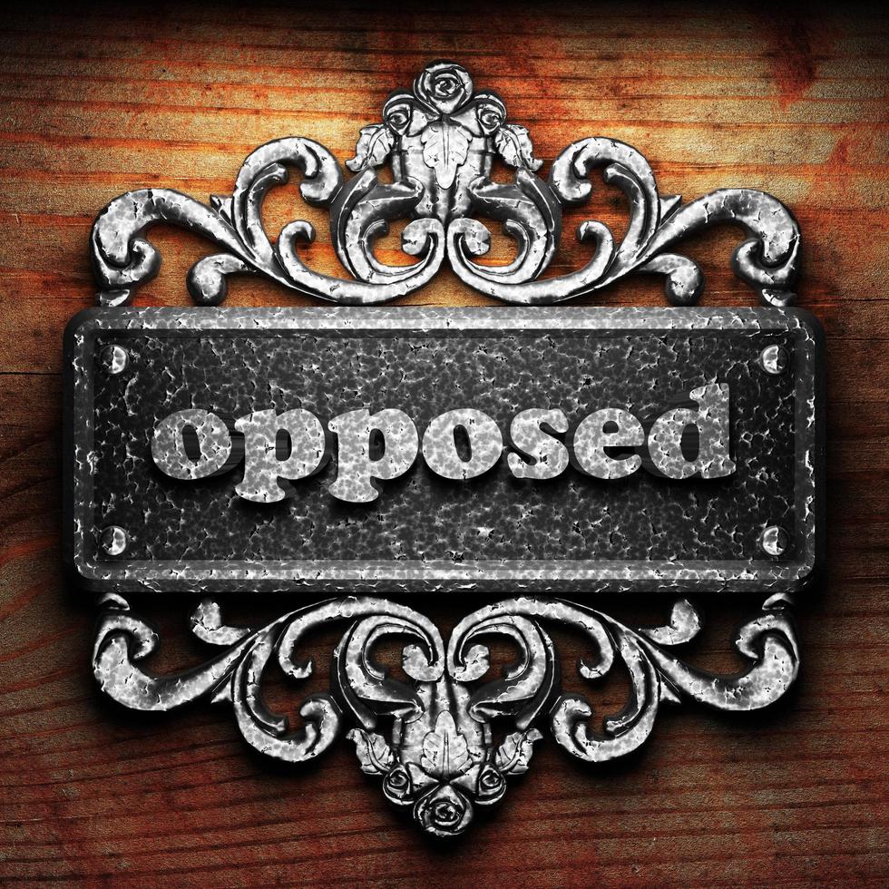 opposed word of iron on wooden background photo
