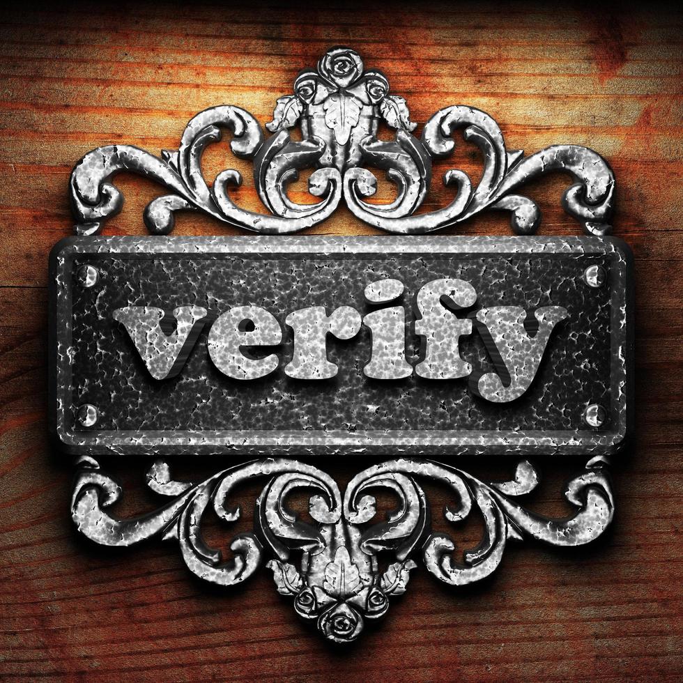 verify word of iron on wooden background photo