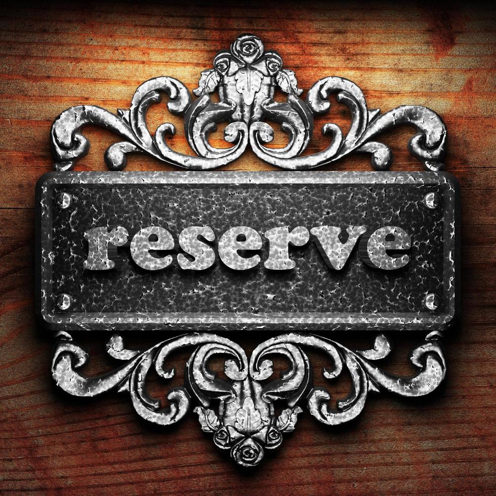 reserve word of iron on wooden background photo
