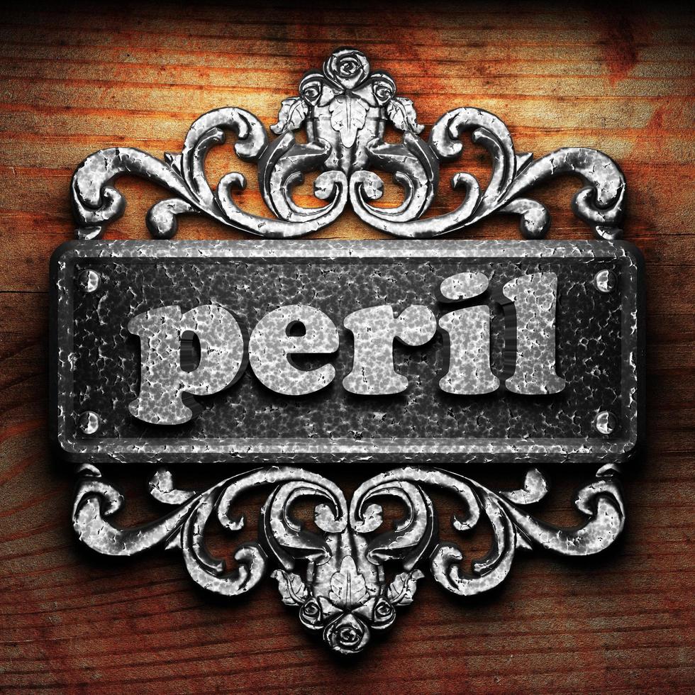 peril word of iron on wooden background photo