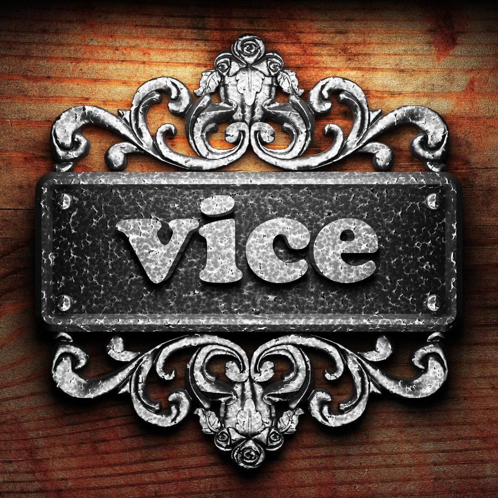 vice word of iron on wooden background photo