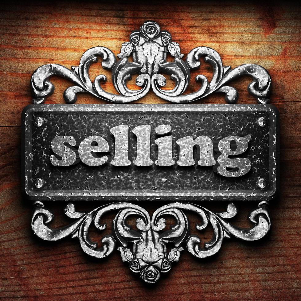 selling word of iron on wooden background photo