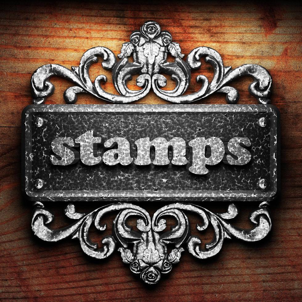 stamps word of iron on wooden background photo