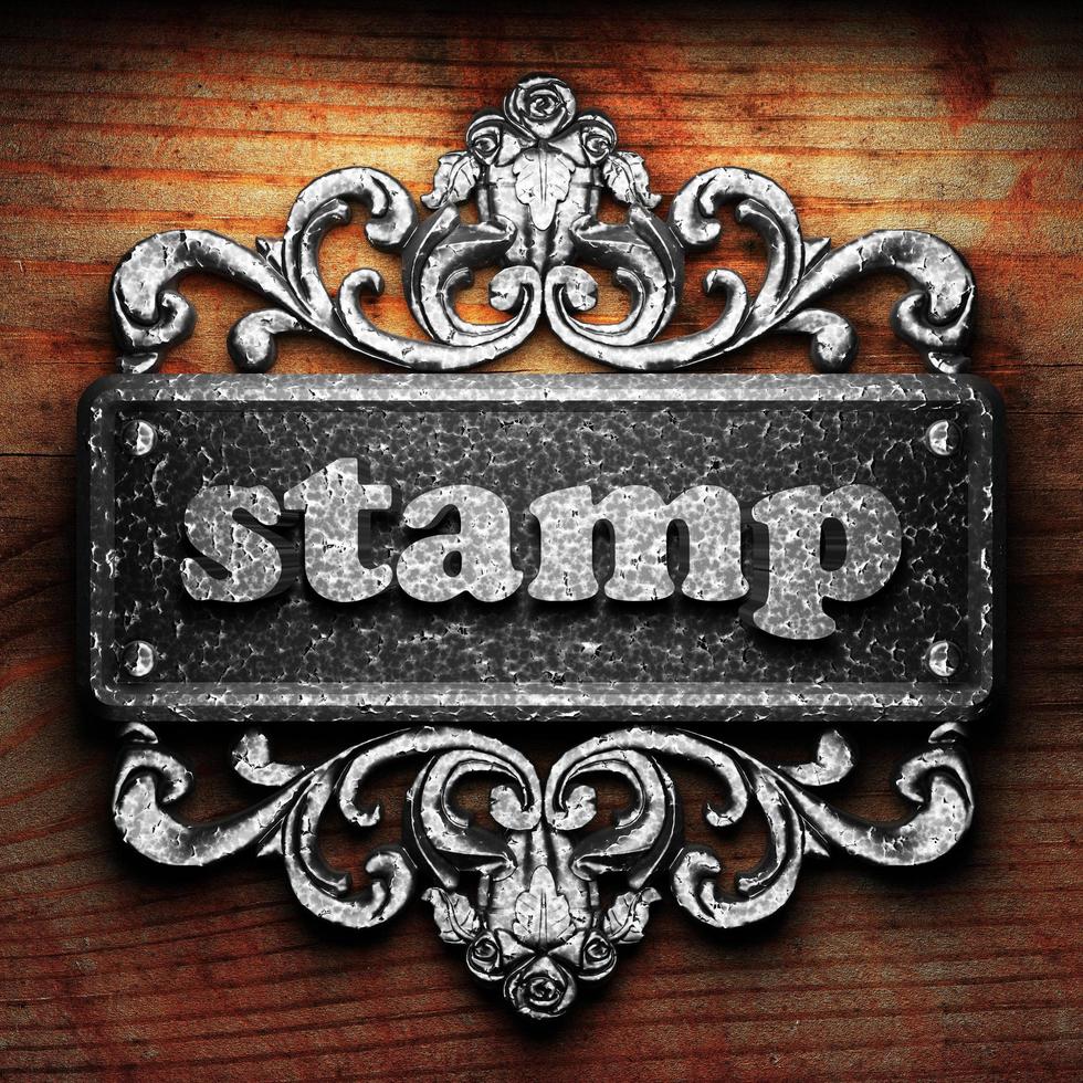 stamp word of iron on wooden background photo