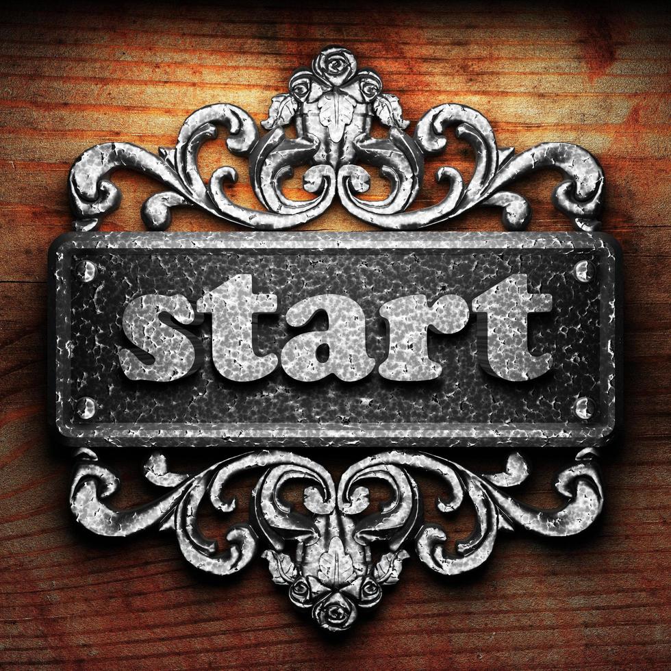 start word of iron on wooden background photo