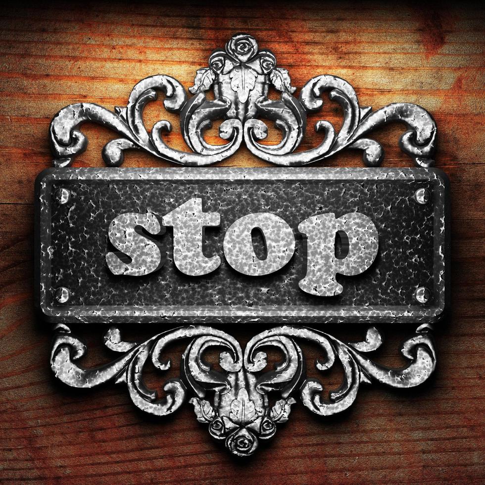 stop word of iron on wooden background photo