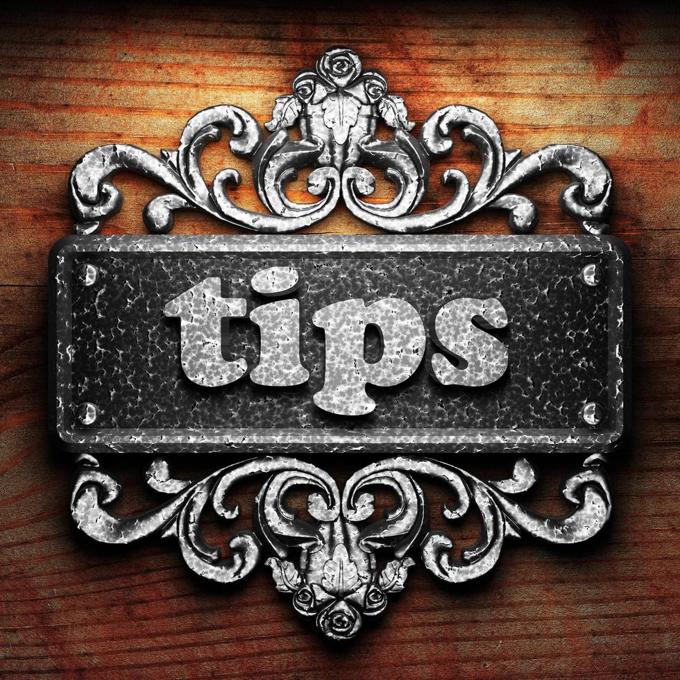 tips word of iron on wooden background photo