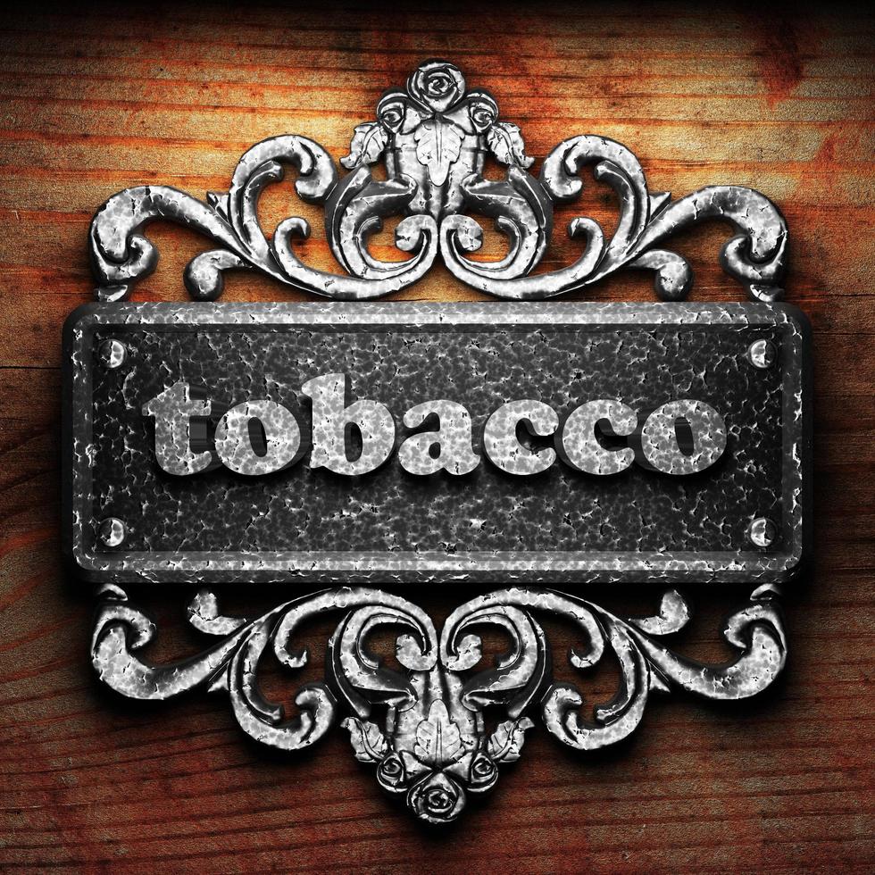 tobacco word of iron on wooden background photo