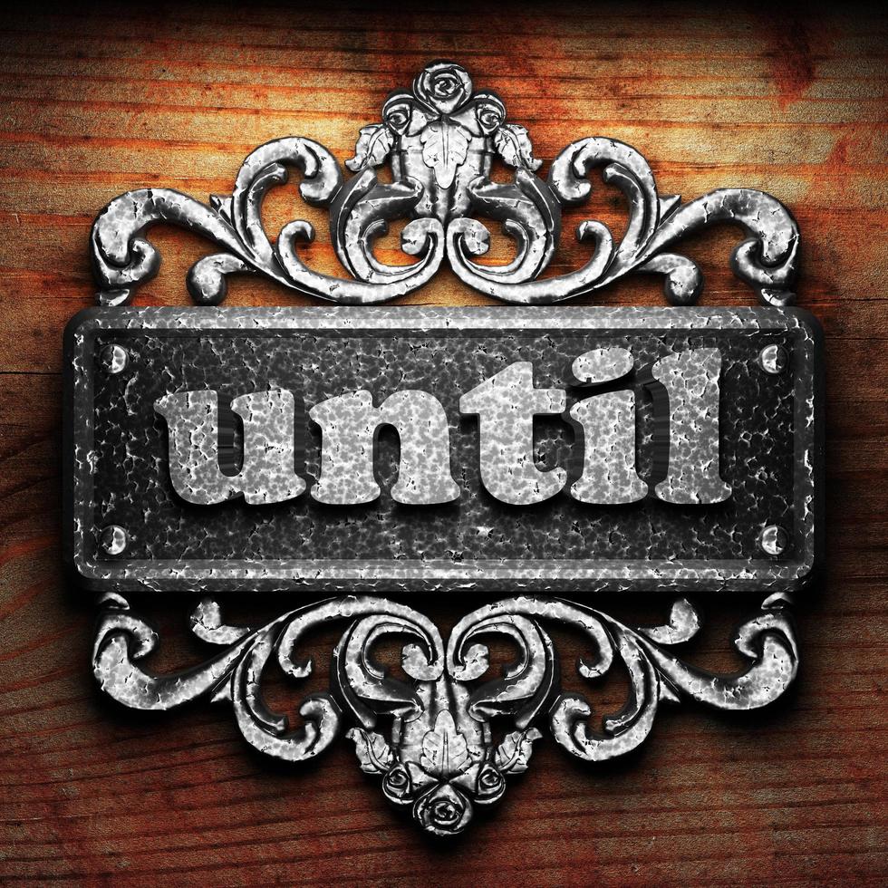 until word of iron on wooden background photo