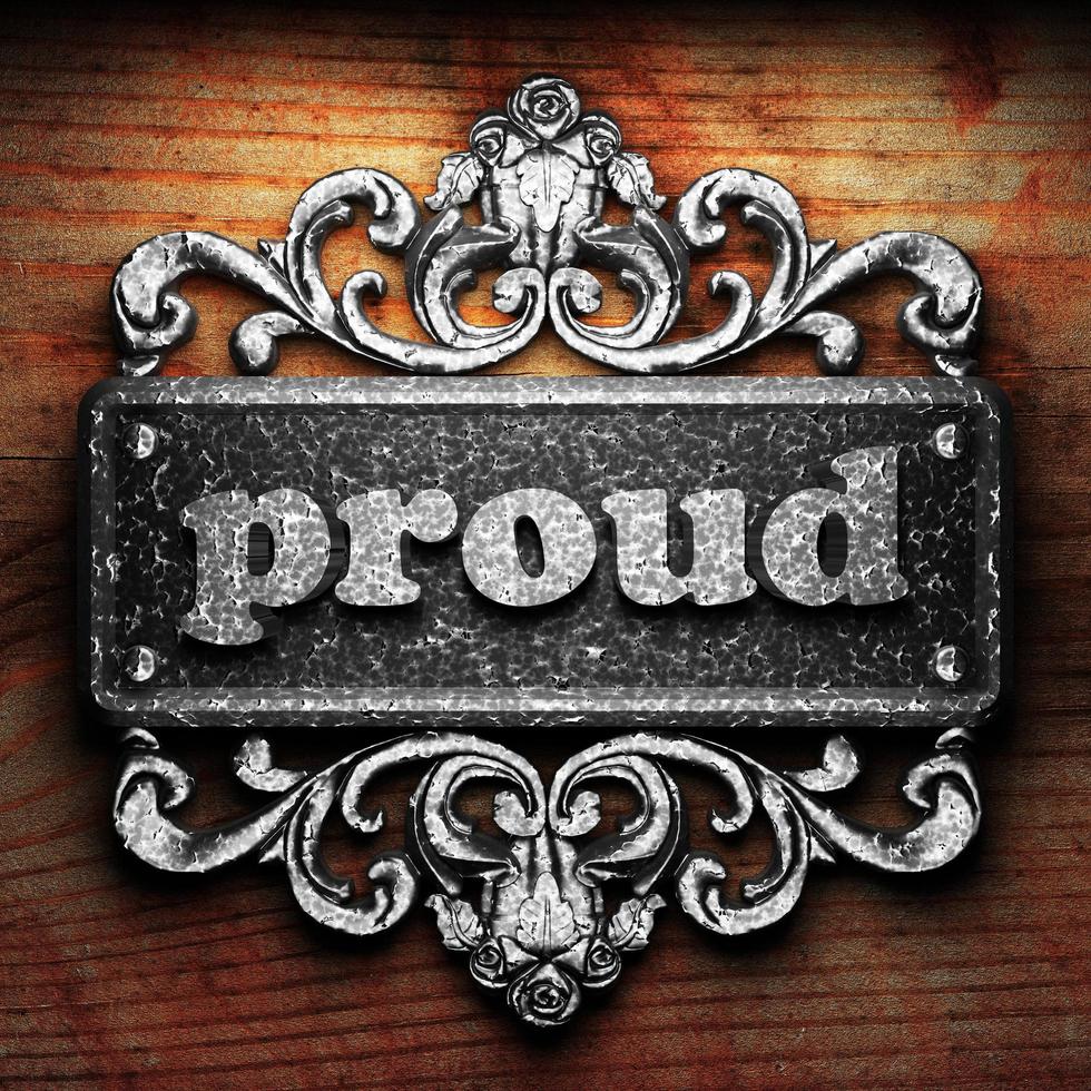 proud word of iron on wooden background photo