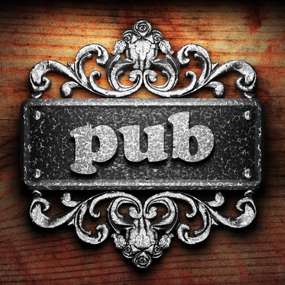 pub word of iron on wooden background photo