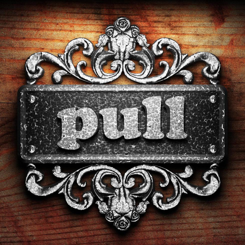 pull word of iron on wooden background photo