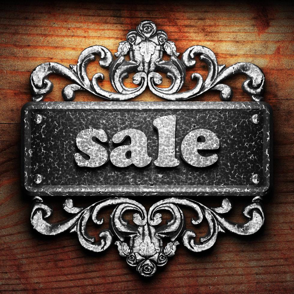 sale word of iron on wooden background photo