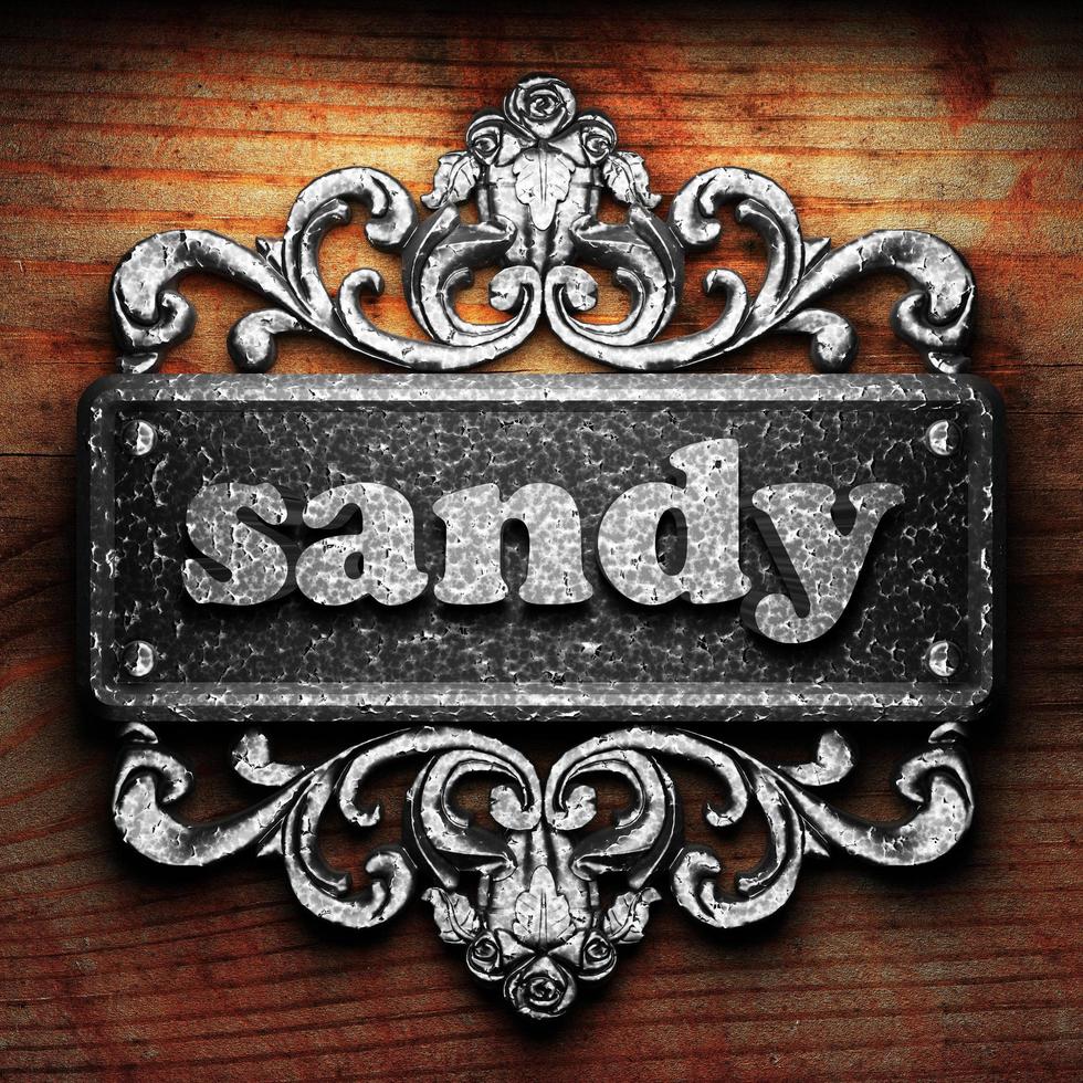 sandy word of iron on wooden background photo