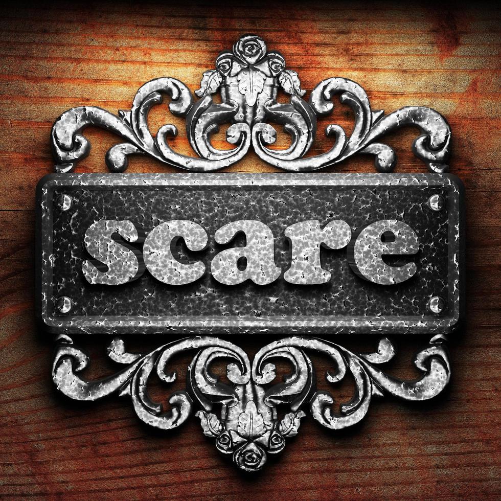 scare word of iron on wooden background photo