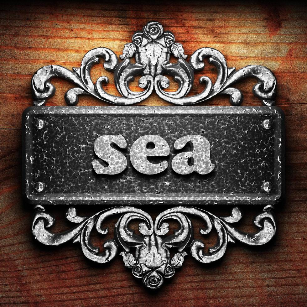 sea word of iron on wooden background photo