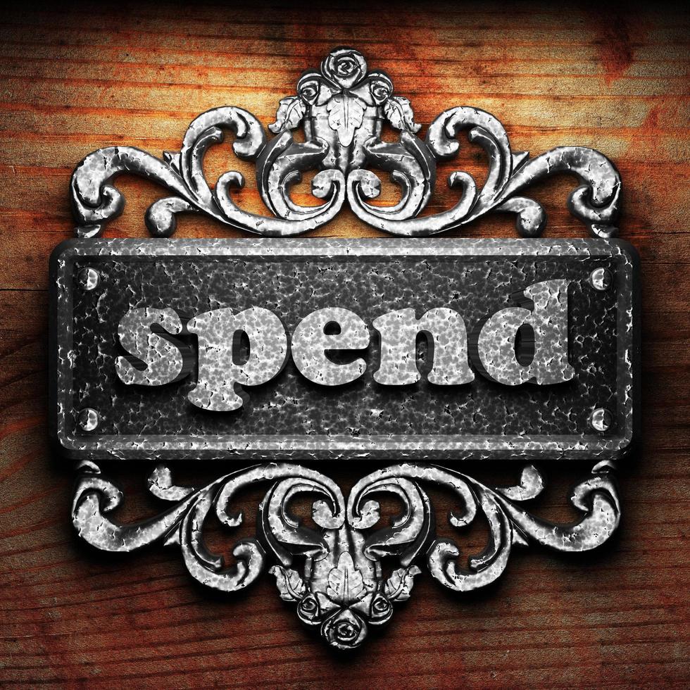spend word of iron on wooden background photo