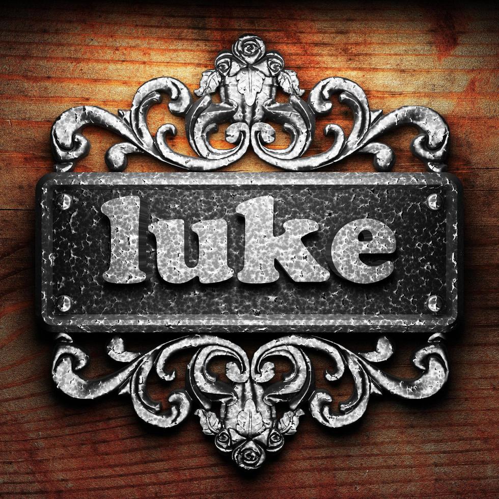 luke word of iron on wooden background photo