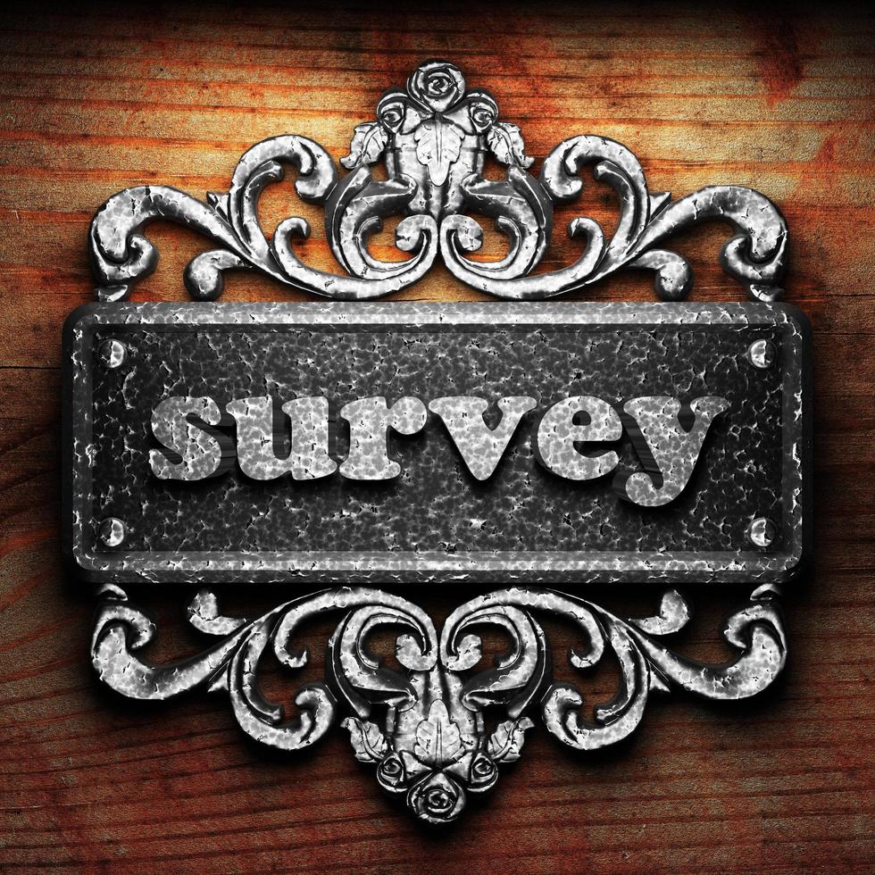 survey word of iron on wooden background photo