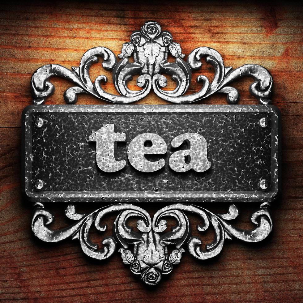 tea word of iron on wooden background photo
