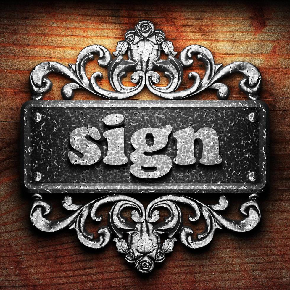 sign word of iron on wooden background photo