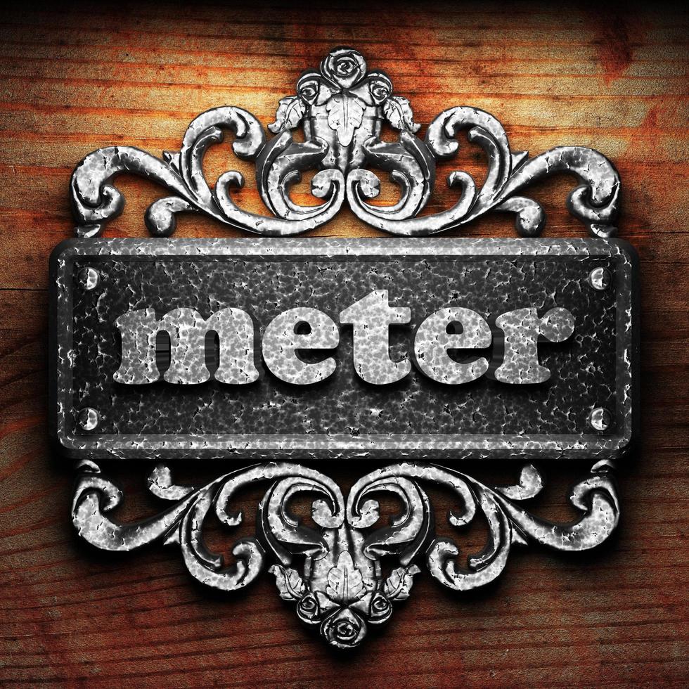 meter word of iron on wooden background photo
