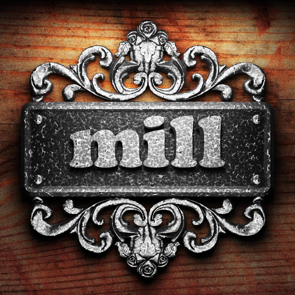 mill word of iron on wooden background photo