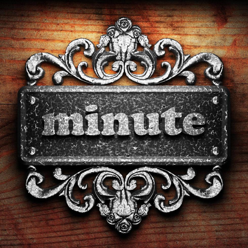 minute word of iron on wooden background photo