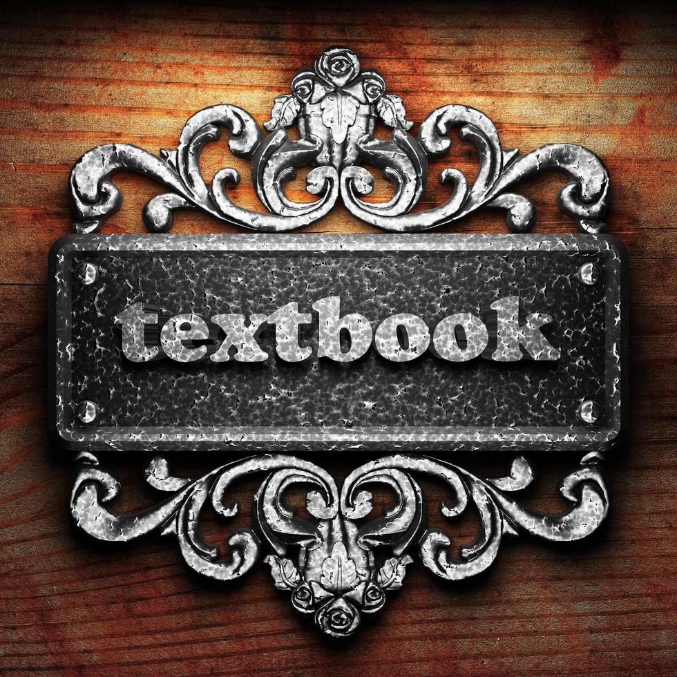 textbook word of iron on wooden background photo