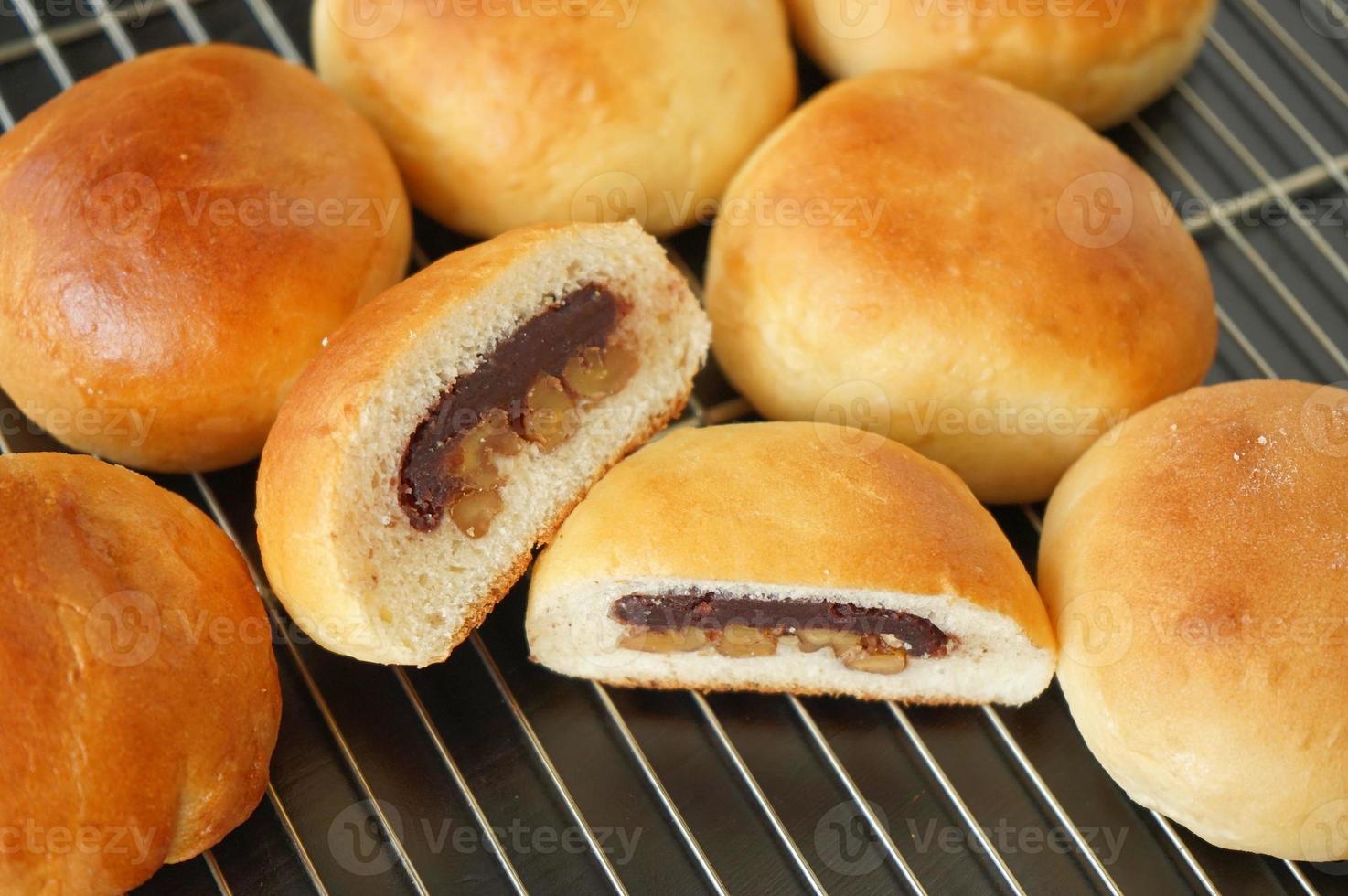 Freshly baked buns lotus red bean cut in half put side by side photo