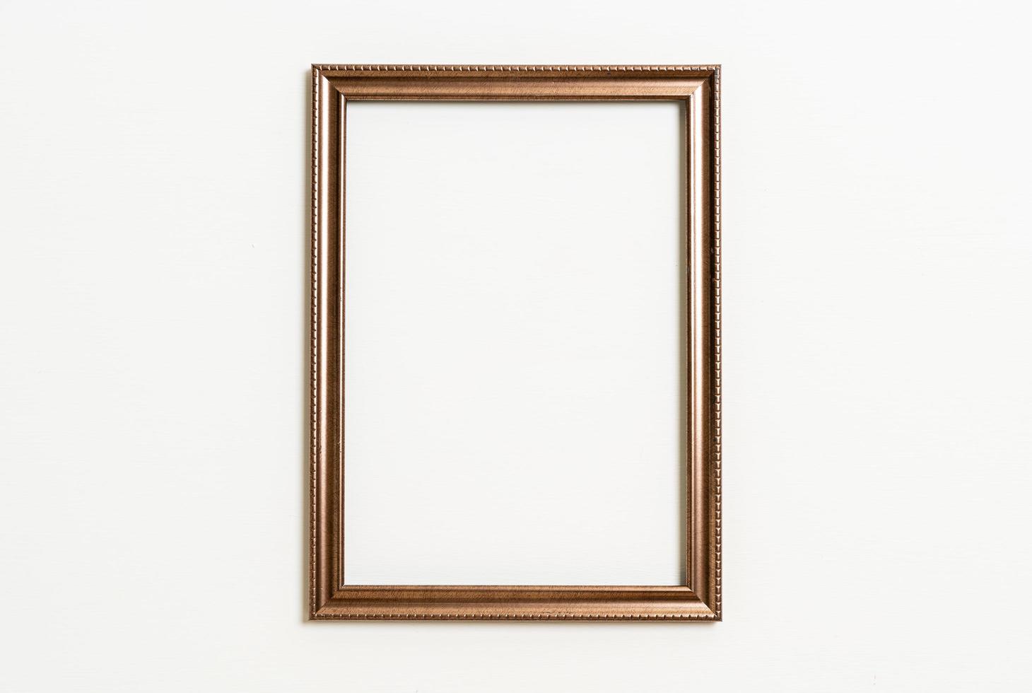 empty picture frame on white wall background photo