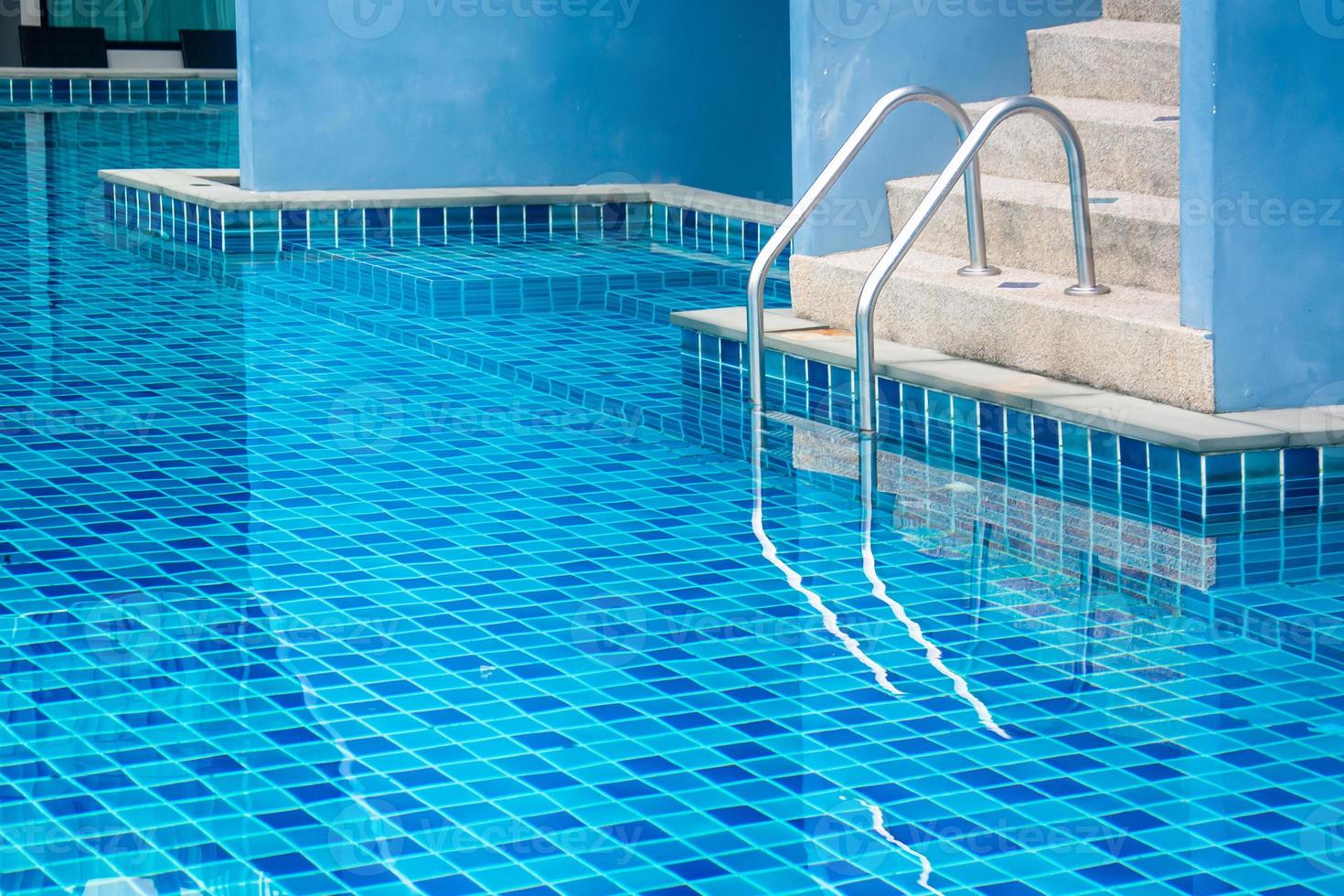 stair of swimming pool with blue water photo