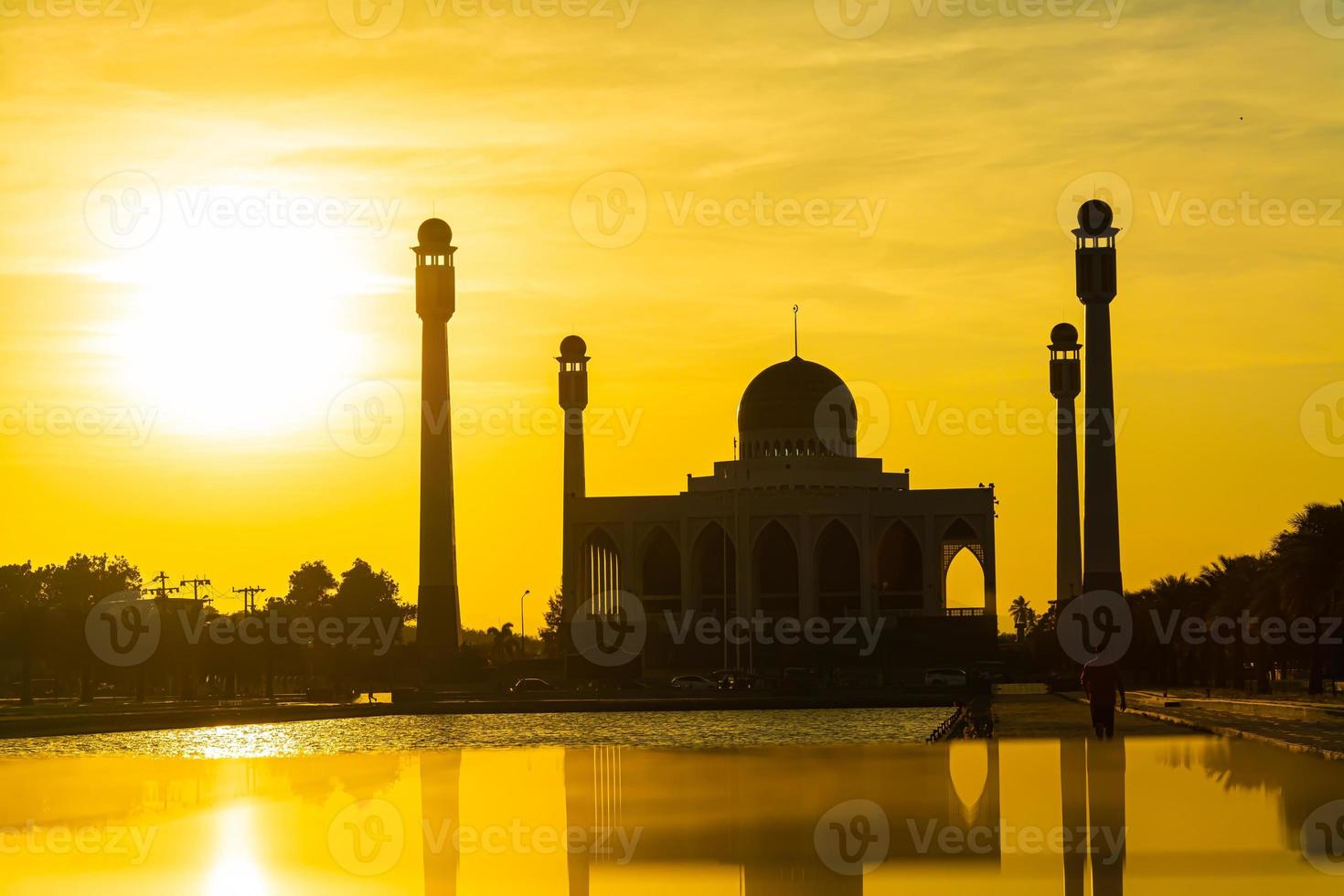 Songkhla Central Mosque in day to night with colorful skies at sunset and the lights of the mosque and reflections in the water in landmark landscape concept photo