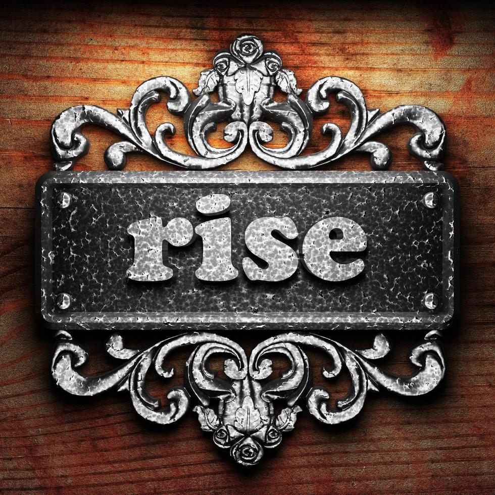 rise word of iron on wooden background photo