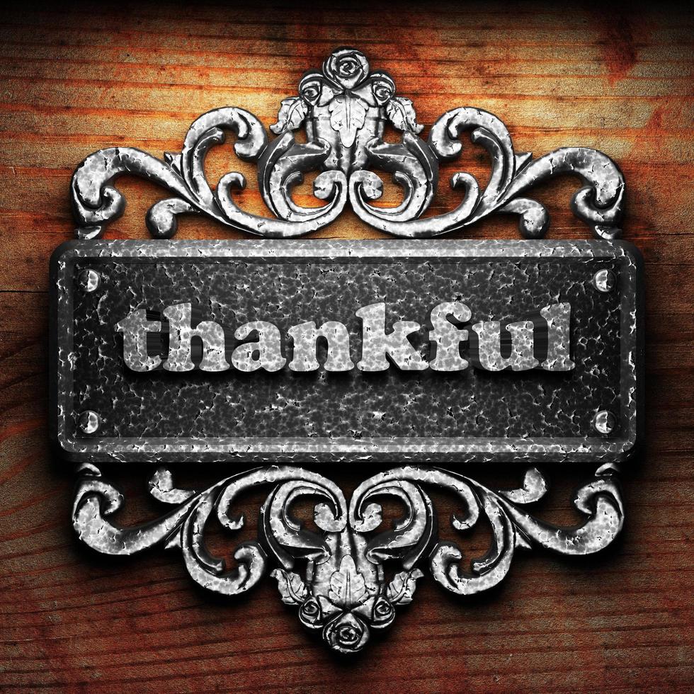 thankful word of iron on wooden background photo