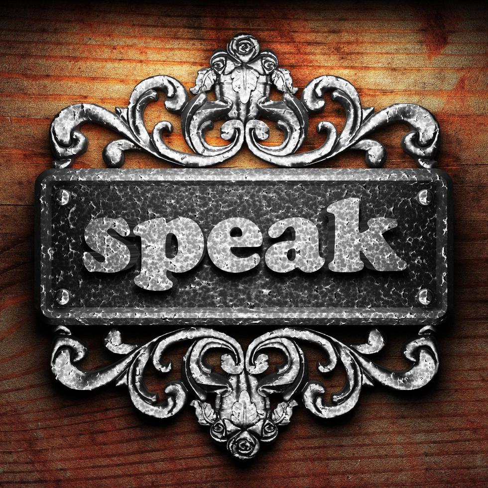 speak word of iron on wooden background photo