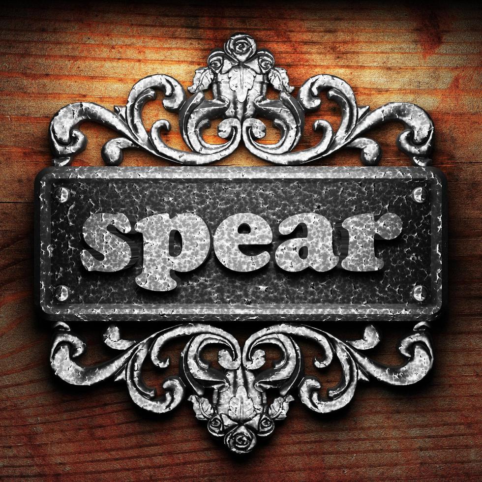 spear word of iron on wooden background photo