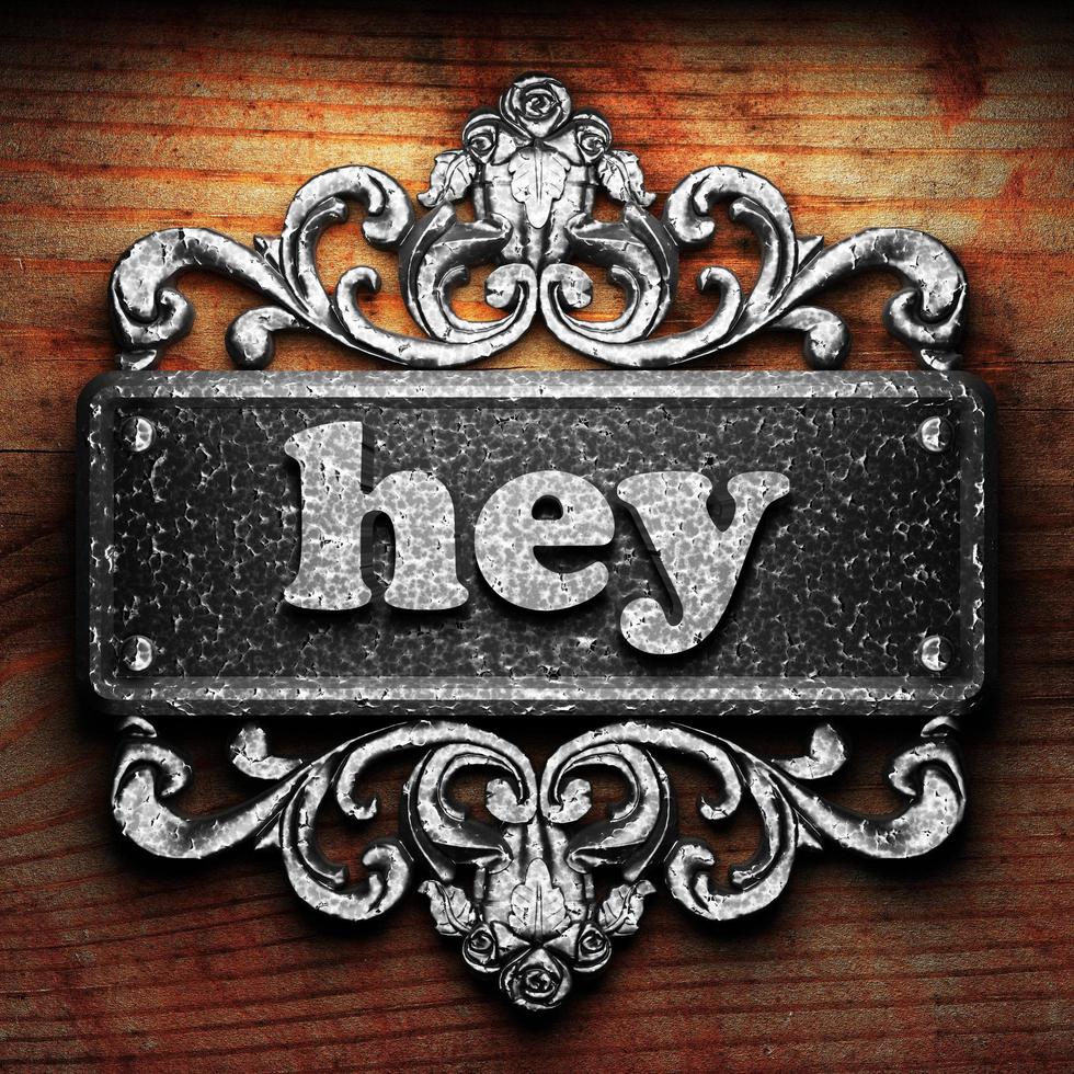hey word of iron on wooden background photo