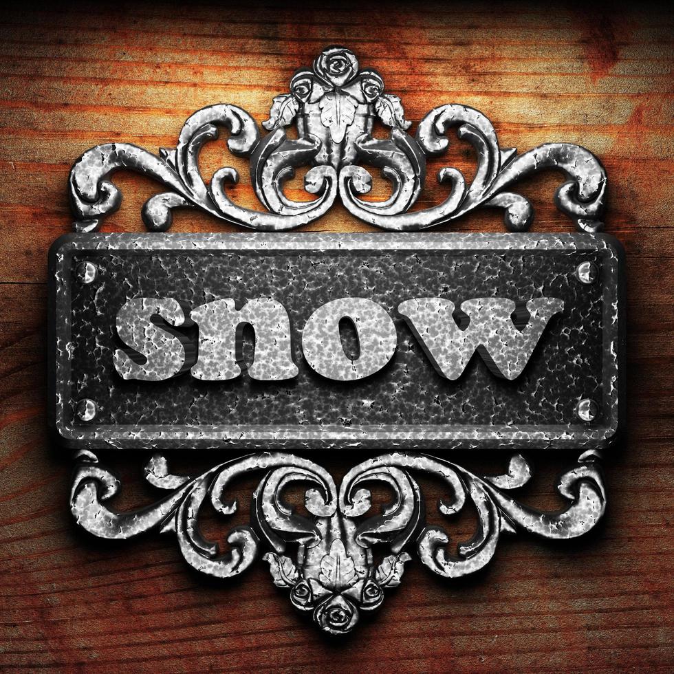 snow word of iron on wooden background photo