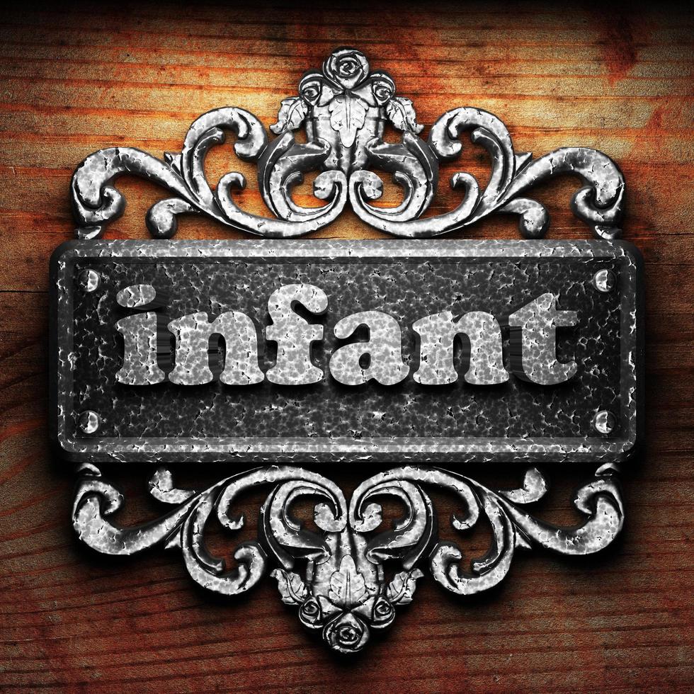 infant word of iron on wooden background photo