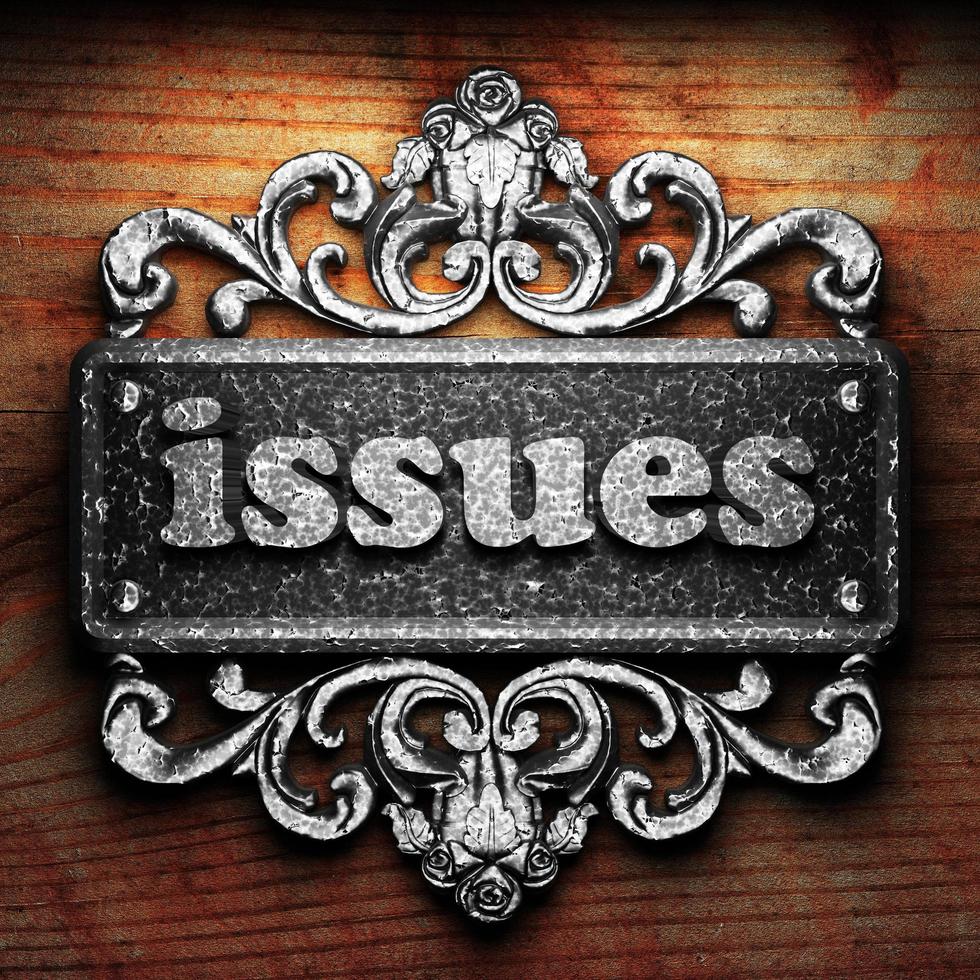issues word of iron on wooden background photo