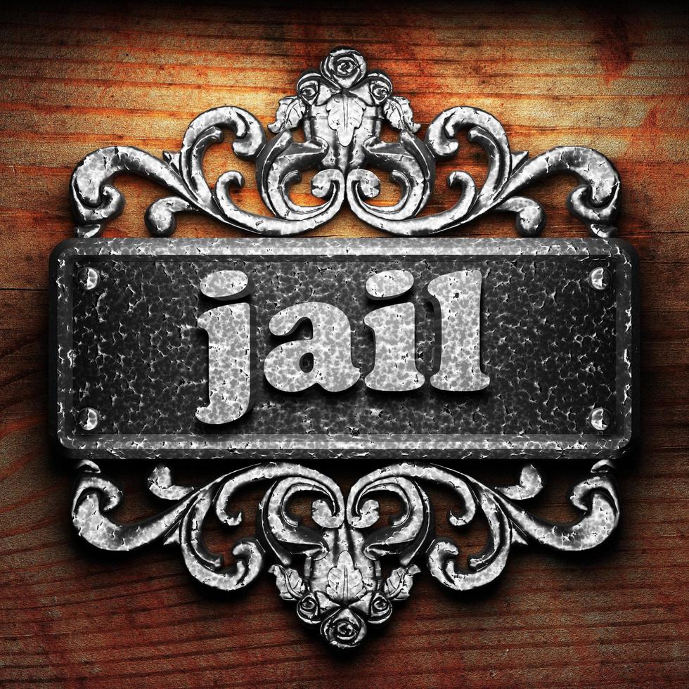 jail word of iron on wooden background photo