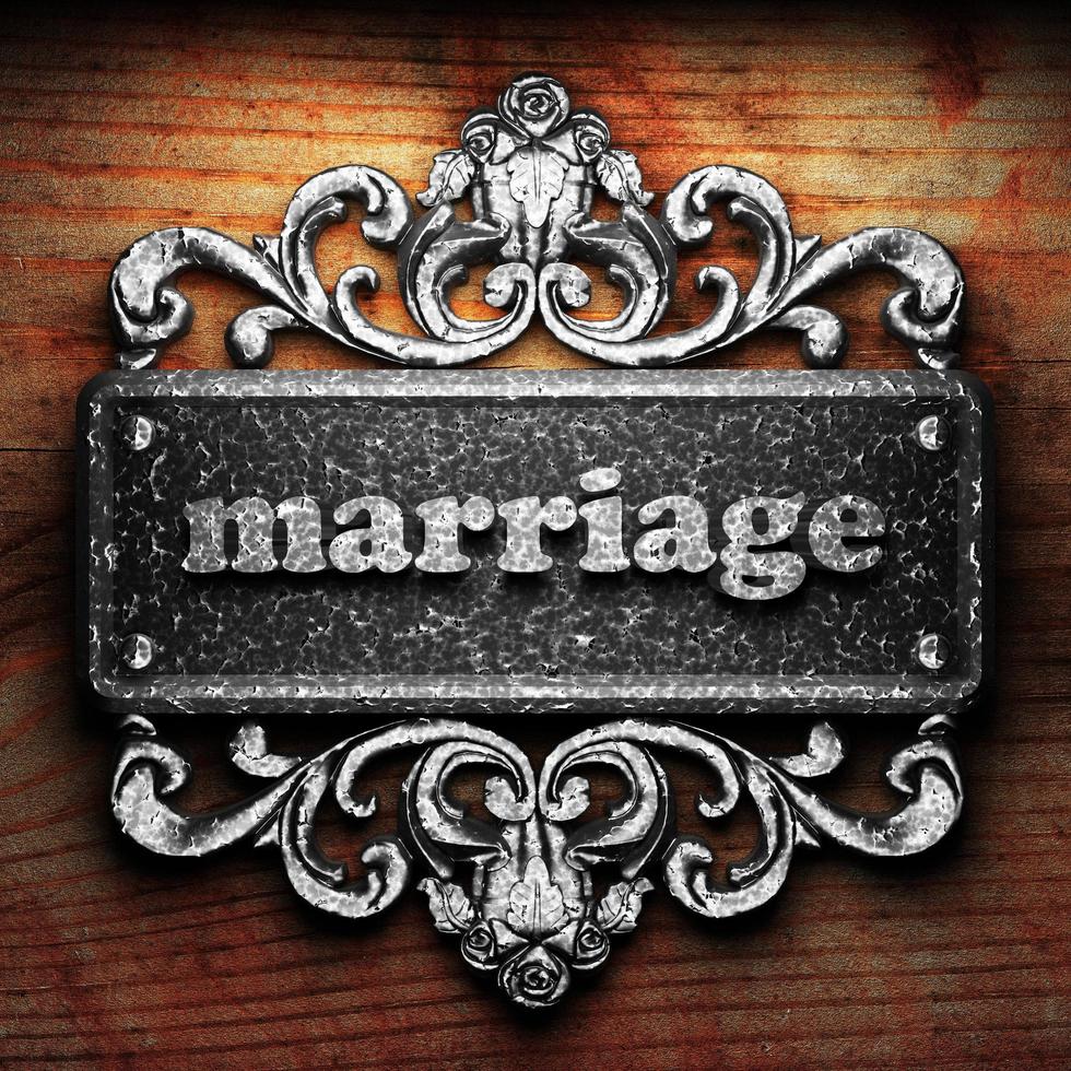 marriage word of iron on wooden background photo