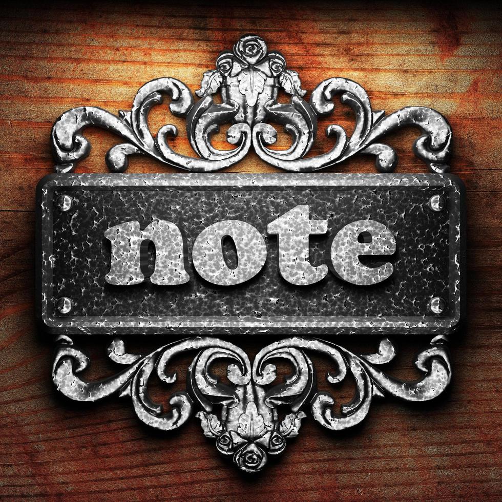 note word of iron on wooden background photo