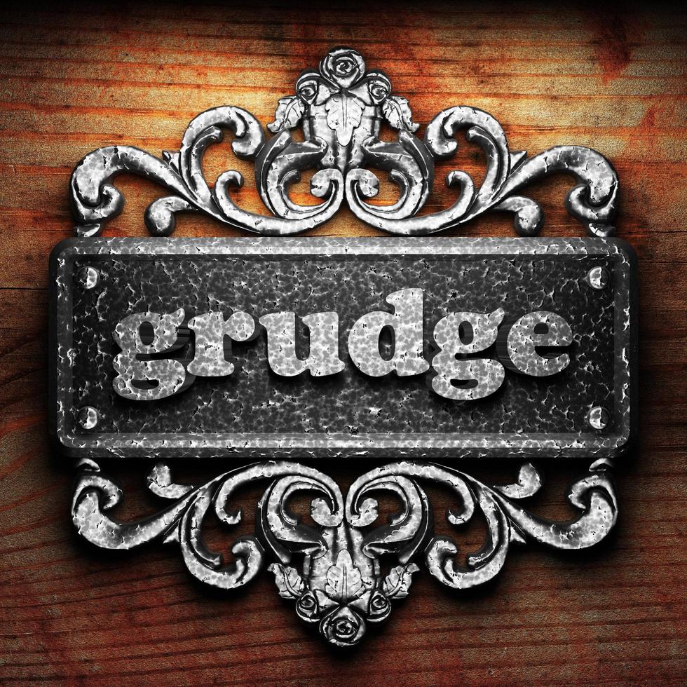 grudge word of iron on wooden background photo